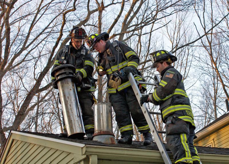 January 30, 2016: Cheshire firefighters inspect the metal chimney of a residence at 25 Arrowleaf Court after being notified of a chimney fire at this location. 