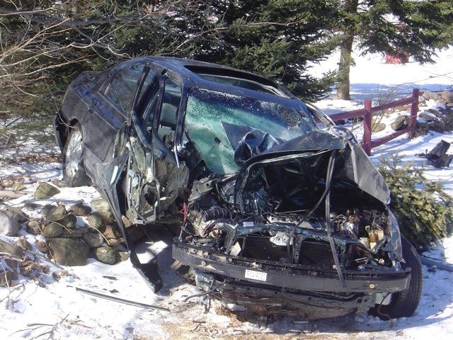 Closer view of the vehicle after striking the tree.