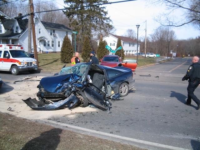 Cheshire Fire Fighters operating at a motor vehicle collision on West Main Street.