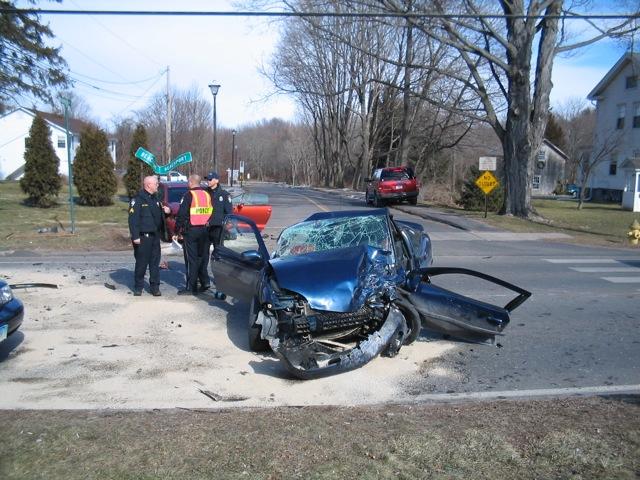 Cheshire Fire Fighters operating at a motor vehicle collision on West Main Street.